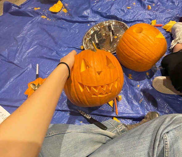 a carved halloween pumpkin by Kalina's feet