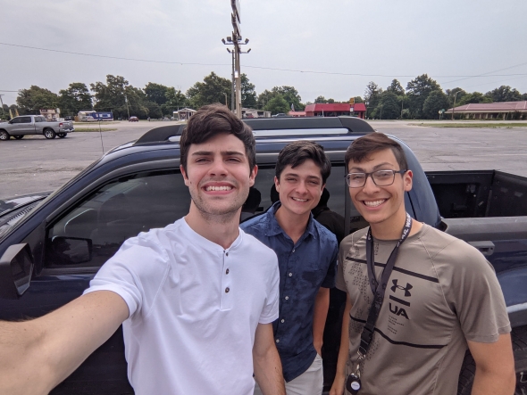 Picture of me and my two best friends in front of my blue pickup truck. 