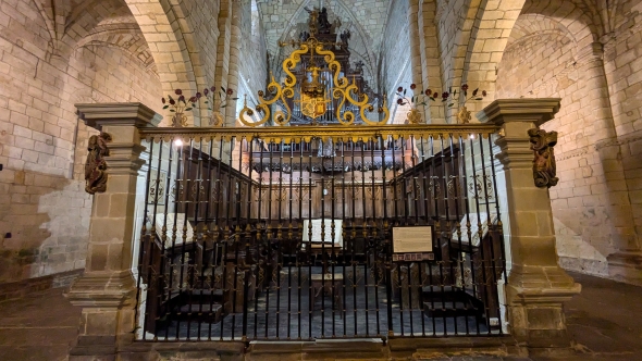 Colegiata de Santa Juliana in Santillana del Mar Spain inside the sanctuary this is a picture of the gate which has old texts and and organ instrument inside of it.
