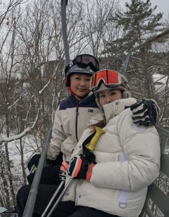 My friend and I riding the ski lift. 