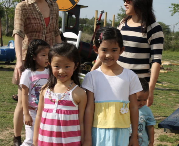 An image of me, Crystal, and my friend Ashley at a birthday party when we were younger. We are both smiling and looking forward to the camera.