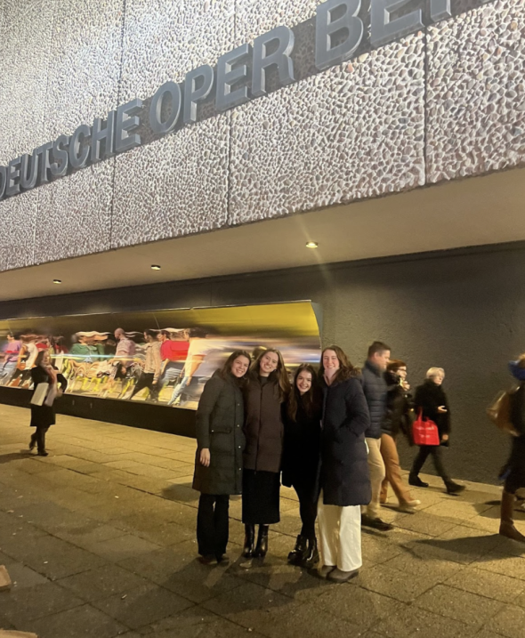 Four Dartmouth students smiling and posing in front of a building in Berlin.