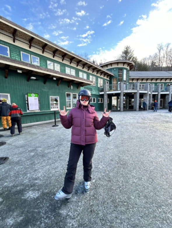 a person standing in front of a ski lodge