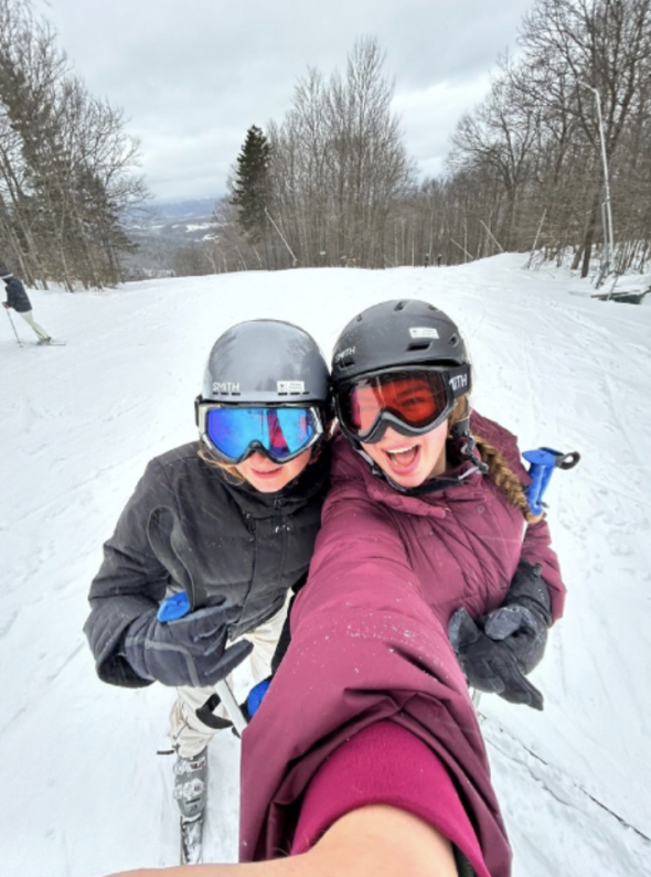 two people taking a selfie while skiing