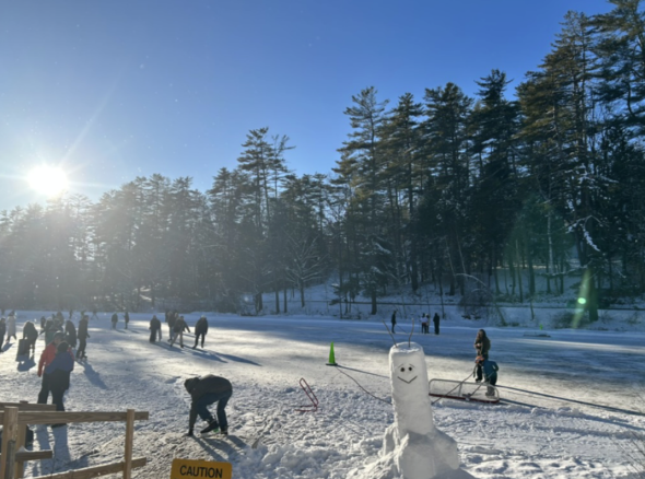 a snowman on a frozen pond