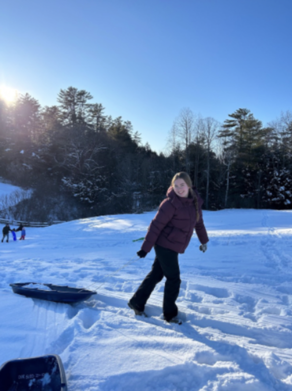 a person pulling a sled in snow