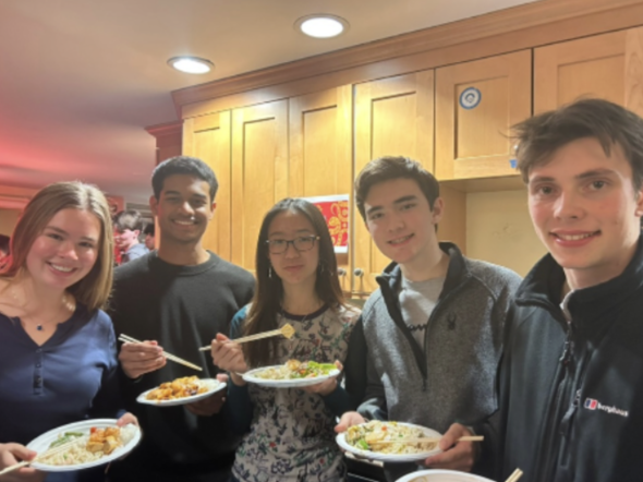 five people holding plates of Chinese food