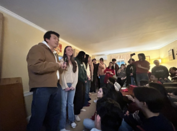 people standing up singing, with people watching