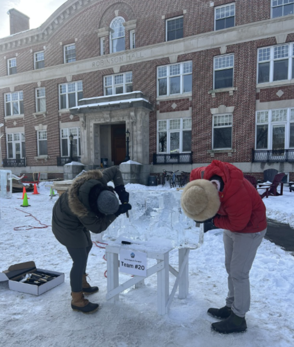people carving into a block of ice