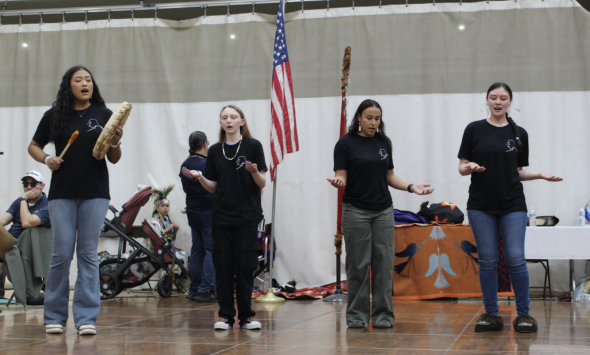 Photo of the Native Alaskan group performing a traditional kayaking song.