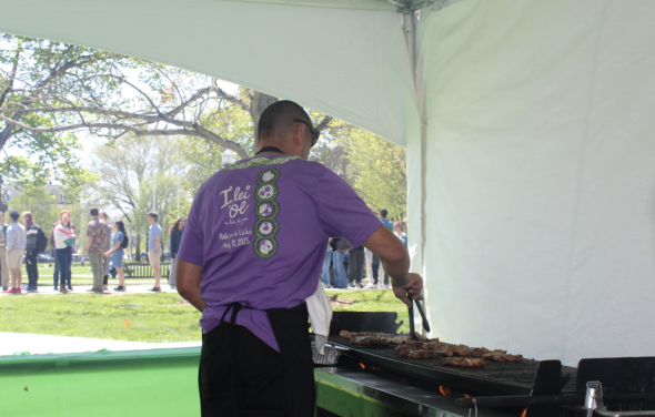 Photo of vendors making traditional Hawaiian food.