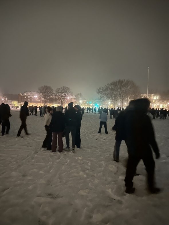 Picture of people huddled in the snow.
