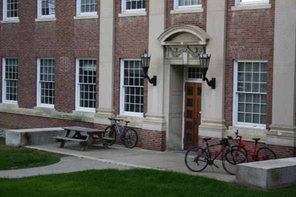 Outside Steele Hall with bikes on the concrete and the grass lawn