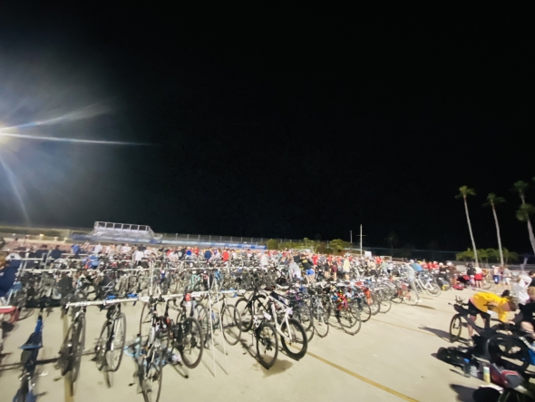 A panoramic view of the transition zone, an area full of road bikes and triathlon gear. 