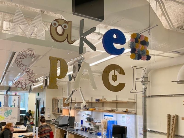 A sign saying "Maker Space", located in the ECSC building. Each letter is made from a different material and hence has different color.