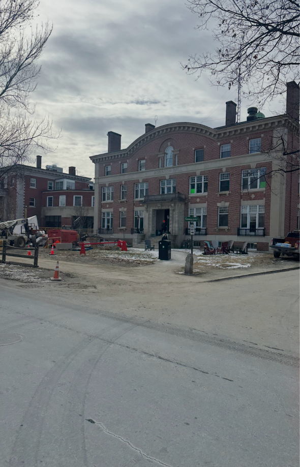 Picture of a brick building with construction happening in front of it.