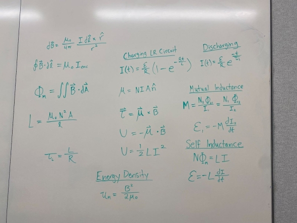 equations written on a white board in green ink in the engineering sciences building.