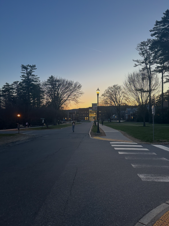A long road with the sunset in the background.