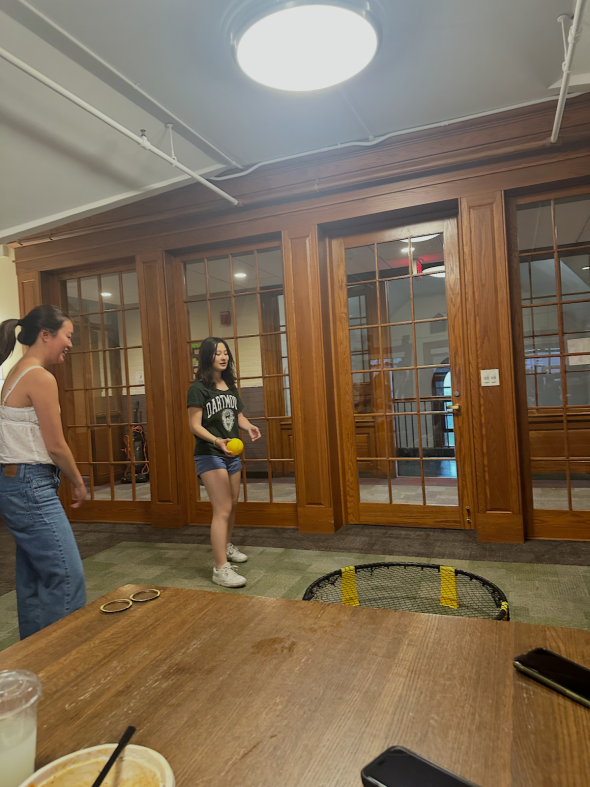 Two students hitting a ball on a net.