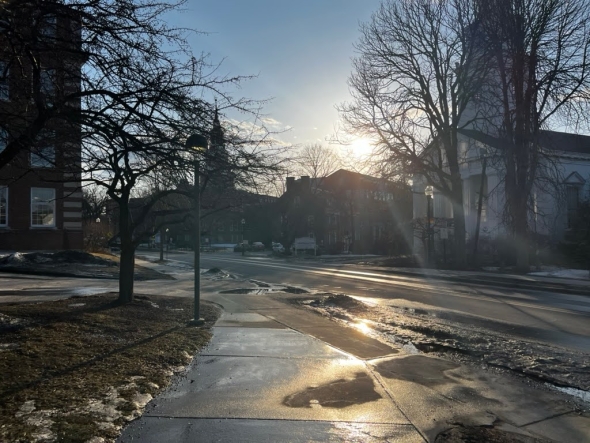 An image of the sun peeking over Dartmouth Campus