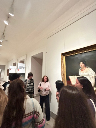a group of people listening to a professor