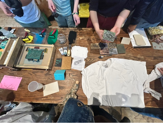 a table with a t-shirt and printing materials
