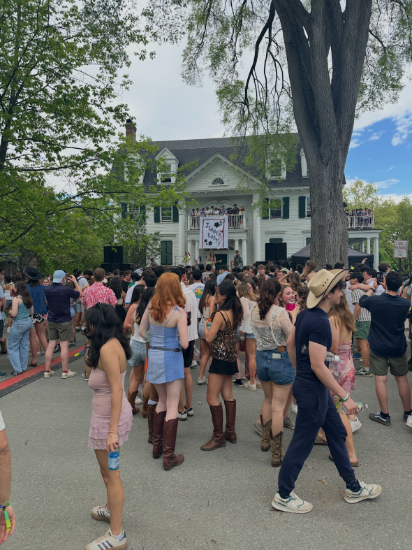 crowd of people in nice outfits outside of a white house.