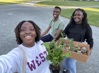 A picture of my friends and I with plants from an orientation event.