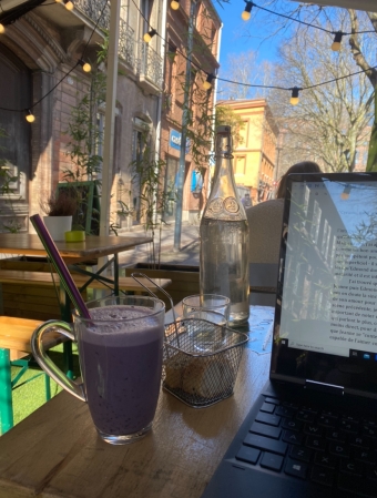 A picture of me studying at a cafe outside.