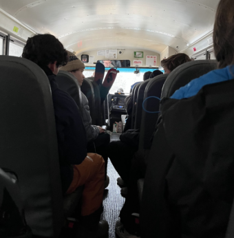 a picture taken from inside a bus. You can see the backs of people's heads.