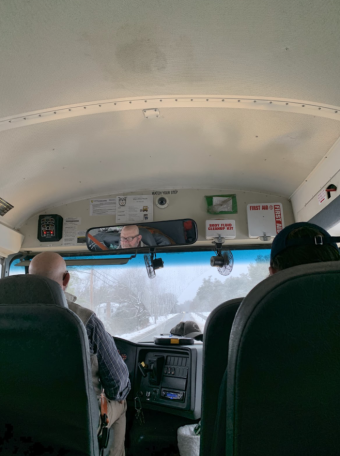 a view of the front of the bus. You can see the snowy road ahead